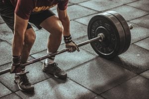 person holding a barbell with weights