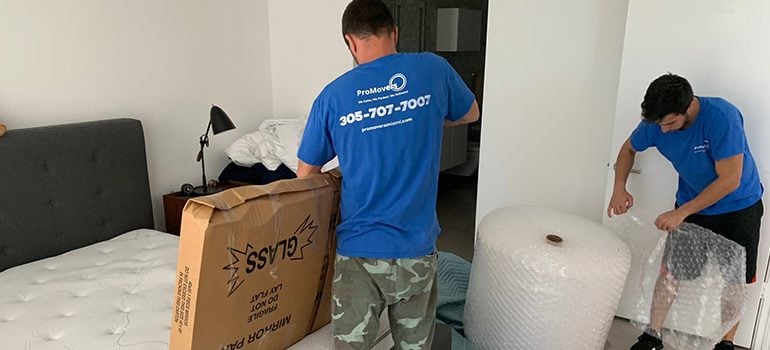 Movers in Fort Lauderdale packing belongings.