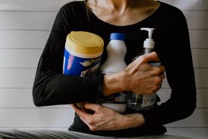 Woman holding chemicals for cleaning furniture