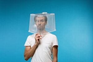 Picture of a man with a plastic box on his head