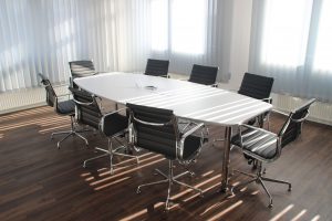 an empty office with desk and chairs around it after managing business hauls in Davie, Fl