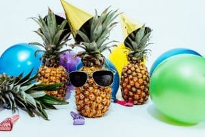 Pineapple with sunglasses and some balloons