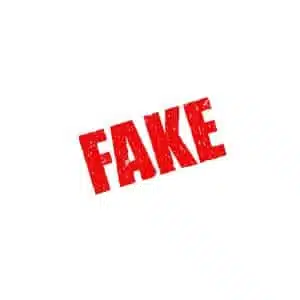 the word Fake written in red letters on a white surface