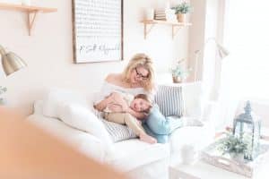 A mother and a child cuddling on a couch. A mother is thinking of ways to make moving easier on children.