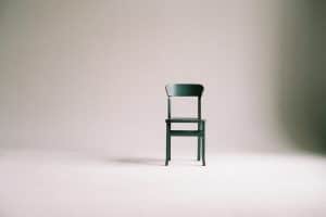 a chair in an empty white room