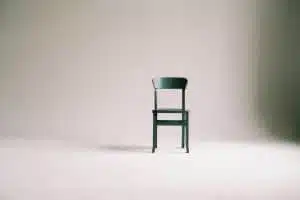 a chair in an empty white room