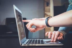 two people looking at a laptop