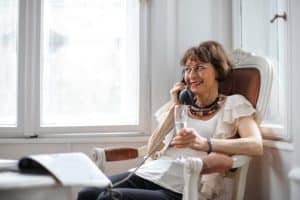 woman sitting and talking on the phone