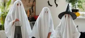 three people wearing ghost costumes