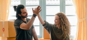 A man and a woman throwing a high five