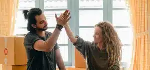 A man and a woman throwing a high five