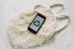 recycling symbol on a phone on a shopping tote