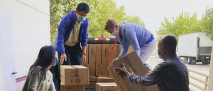 People loading moving boxes on a moving truck