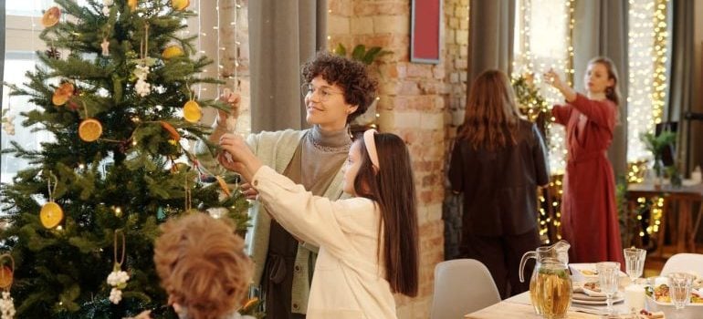Family decorating a christmas tree