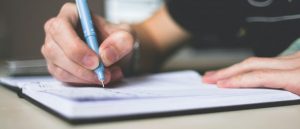 A person writing down in a journal