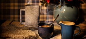 two mugs with hot drinks and a soup bowl