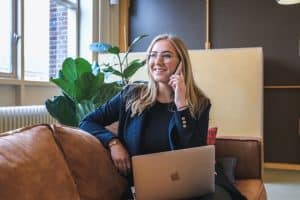 woman with a laptop talking on the phone