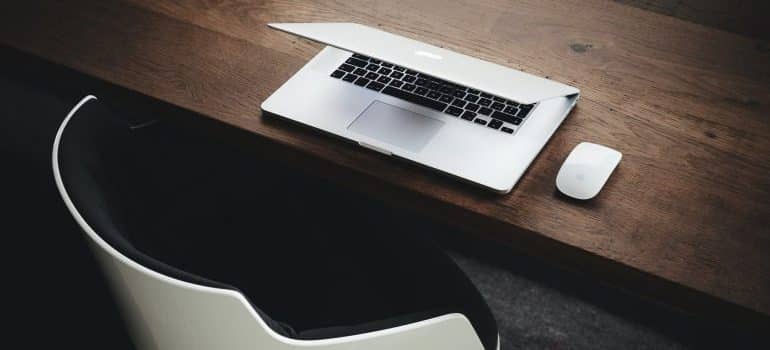 Laptop on a desk as a reminder to start searching as soon as possible