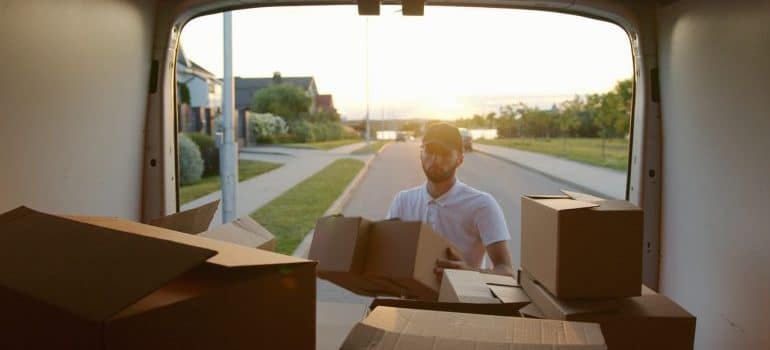 a man loading the truck with boxes