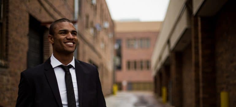 A happy man in the suit smiling 