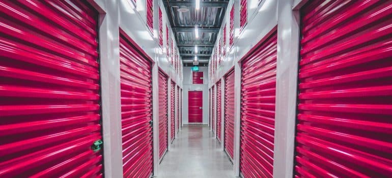 hall with storage units with pink metal doors