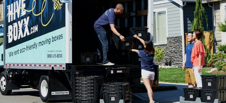 Professional movers putting items into the truck