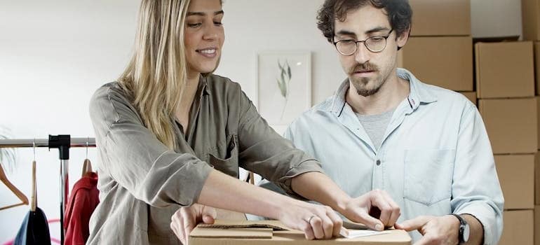 A couple about to pack and move designer clothes and shoes