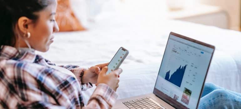 A woman checking business stats on her laptop