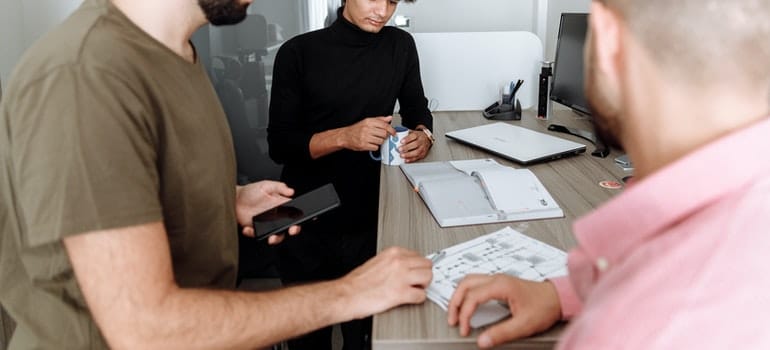 Men planning laboratory equipment relocation.