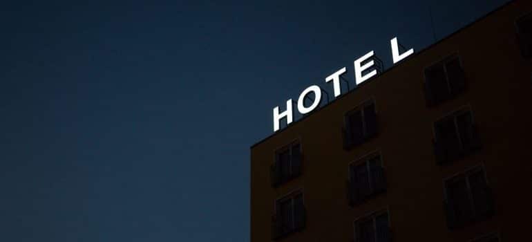 A neon hotel sign on the roof of a building