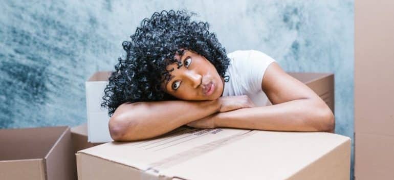 Woman leaning on a box