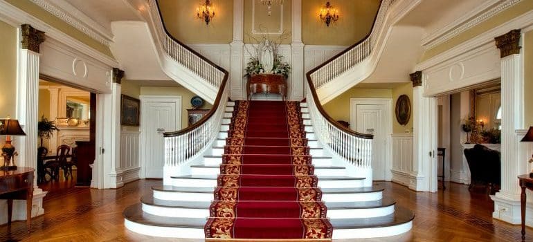 white staircase with red carpet