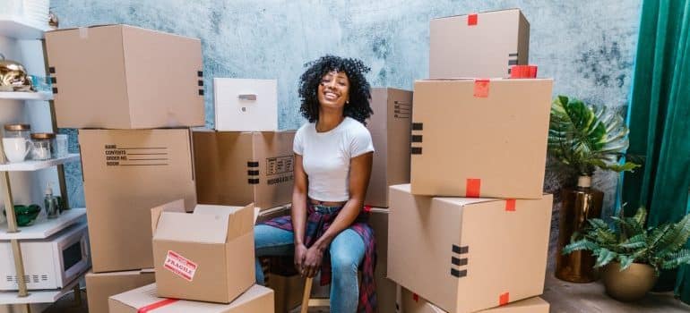 girl surrounded by cardboard boxes 