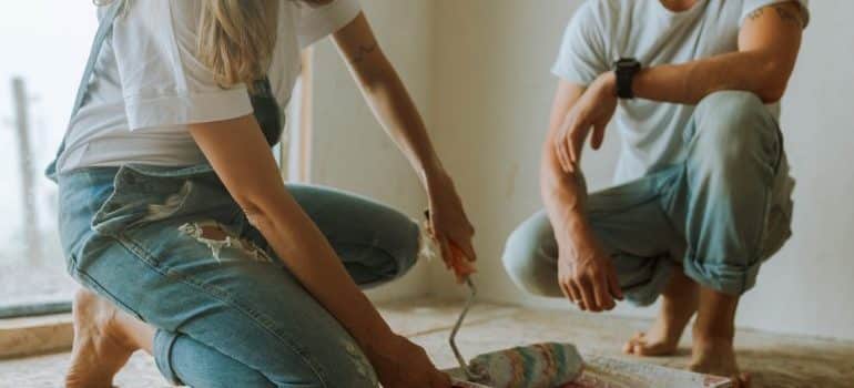 Man and woman doing home painting