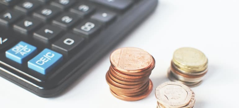 A calculator and a few pennies are on a table.