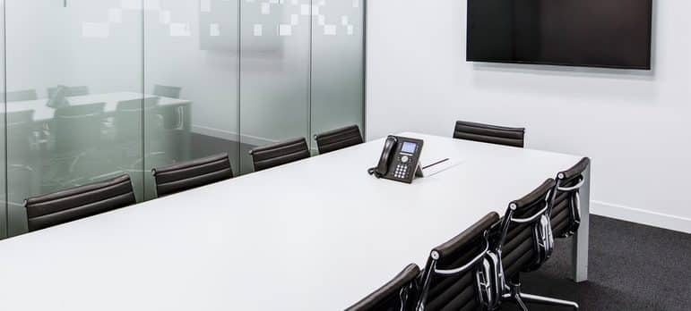 a conference room with chairs and a tv