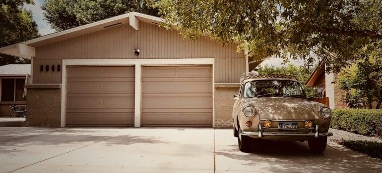 white vehicle in front of a garage