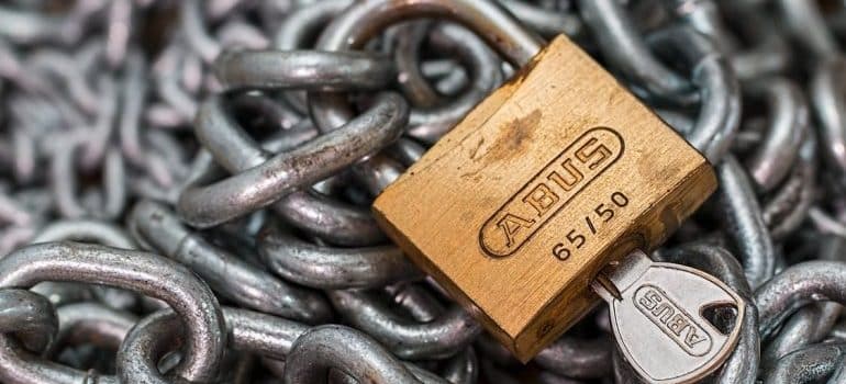 A gold-colored abus padlock with key