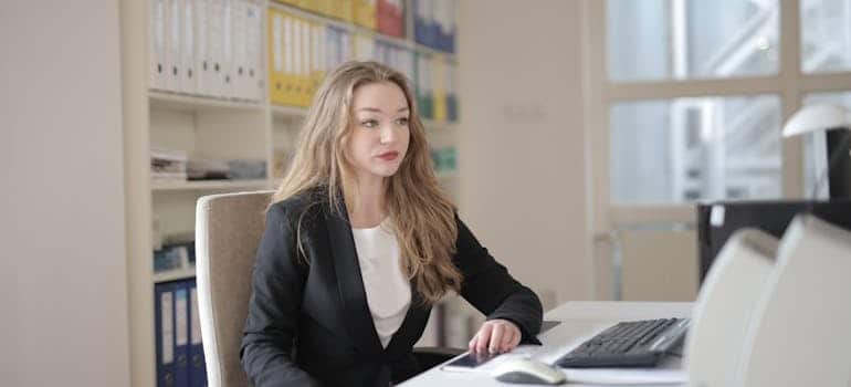 Woman in black blazer sitting in an office