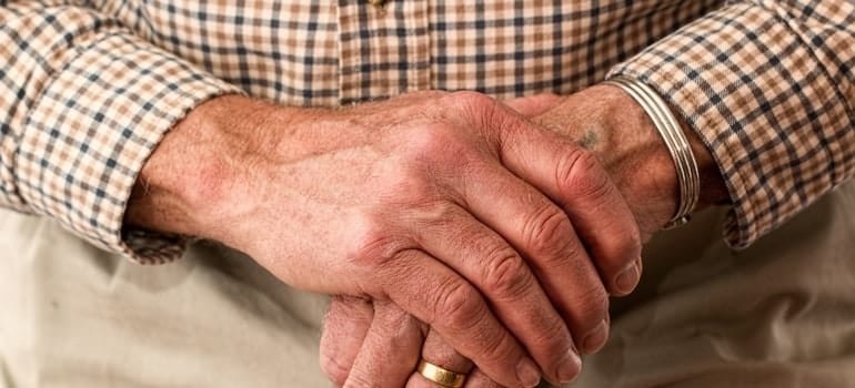 An older man is holding a cane