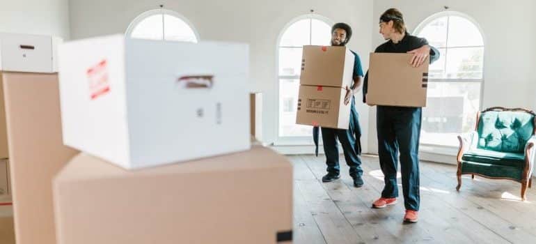 Professional movers carrying boxes