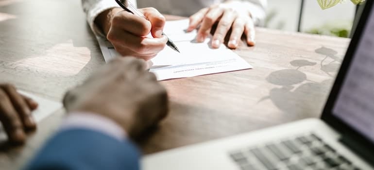 person signing a document