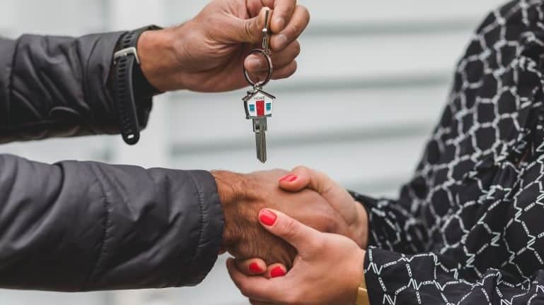 a person getting keys after buying a luxury property in South Miami