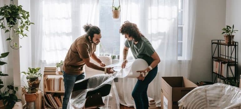 a man and a woman packing a chair