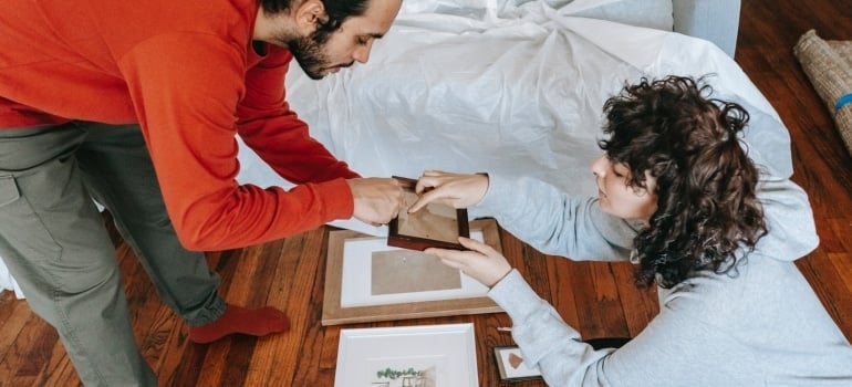 A couple packing and moving valuable art to another state