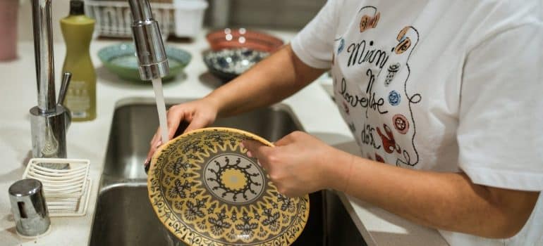 a woman washing the dishes