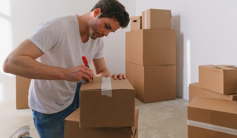 a man labeling boxes