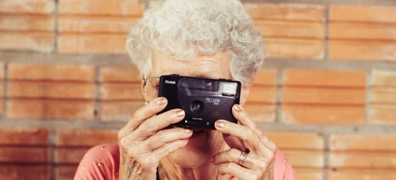 grandma taking a picture after reading our relocation tips for seniors in Coral Gables