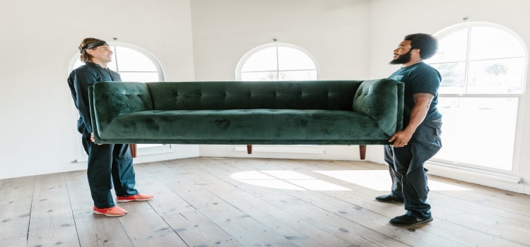 two men moving a couch 