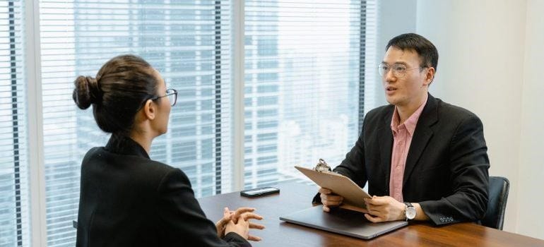 a man and a woman talking in an office